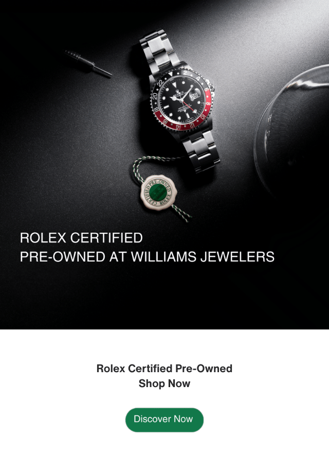 Vintage Rolex GMT set against a dark background with light filtering in highlighting the watch.